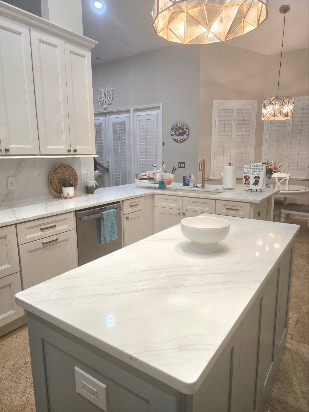 White raised panel kitchen with gray island and stunning marble quartz countertop close-up by 1 Stop Cabinets