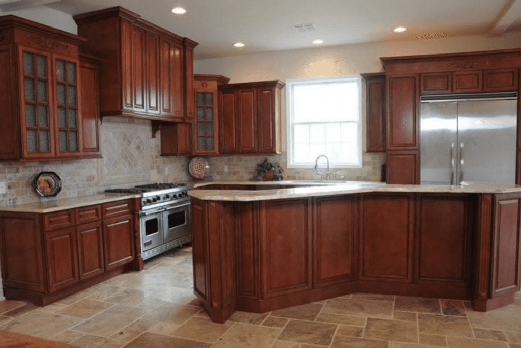 Rich cherry wood kitchen with granite countertops by 1 Stop Cabinets