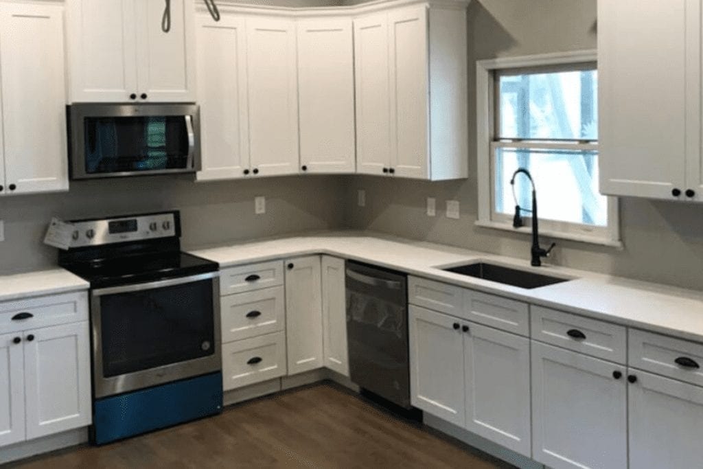 White raised panel kitchen with stainless appliances by 1 Stop Cabinets